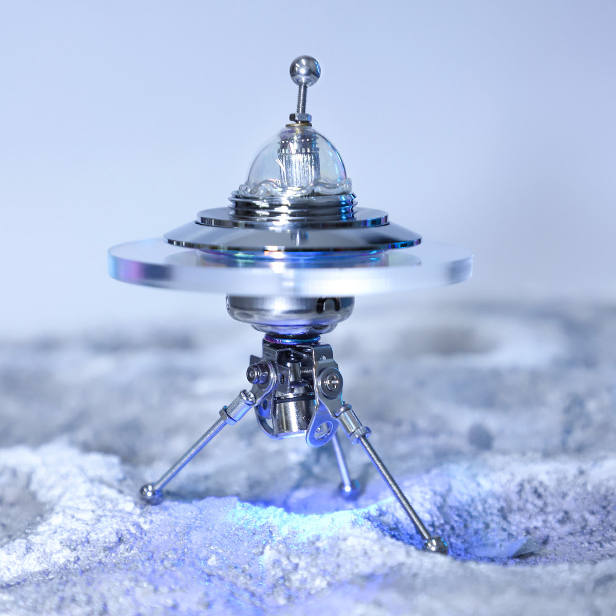 Model of a flying saucer on a snowy landscape
