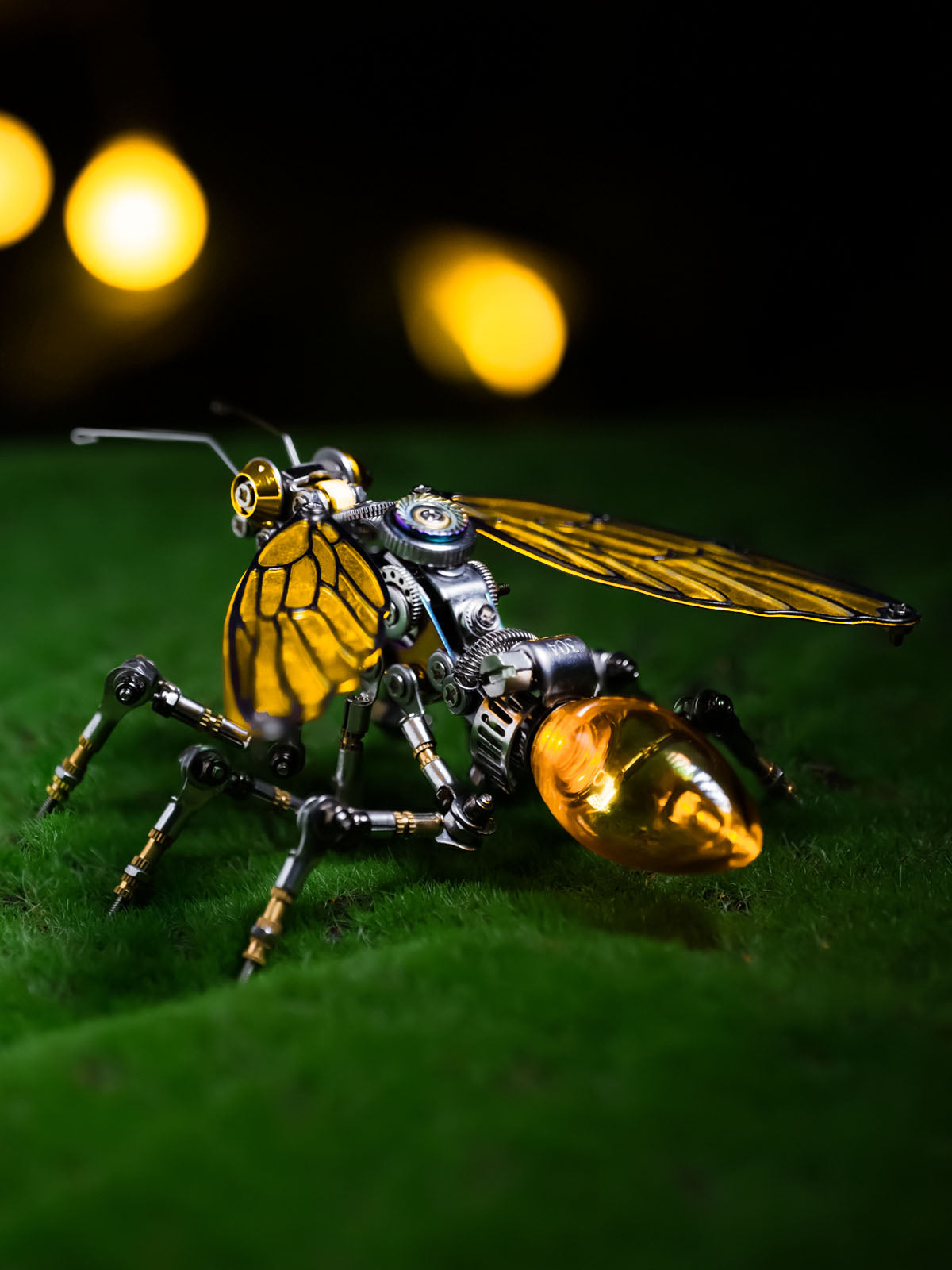 A model of a mechanical ant with color-shifting wings and glowing energy points, placed on a simulated natural terrain.