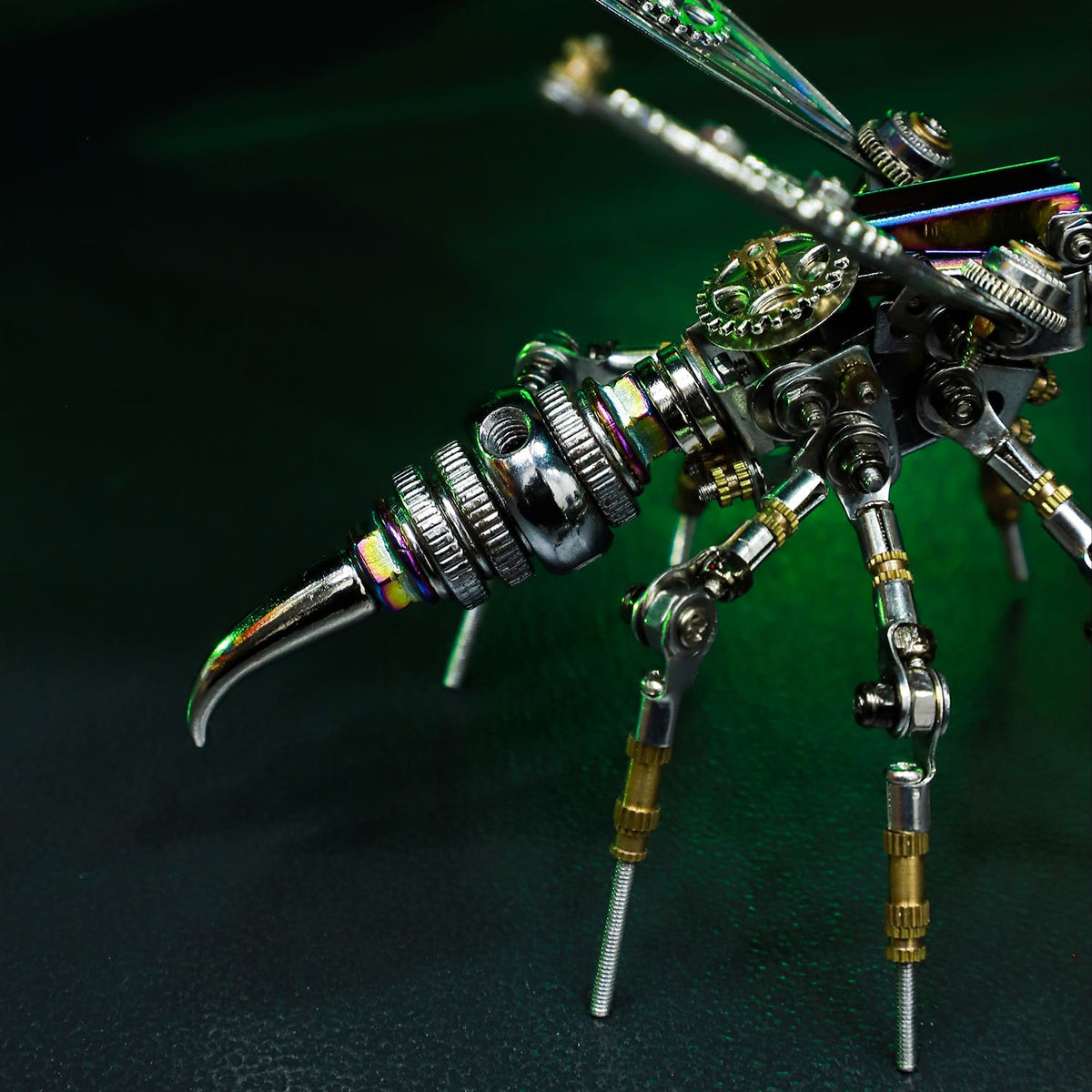 Metallic insect sculpture on a dark background