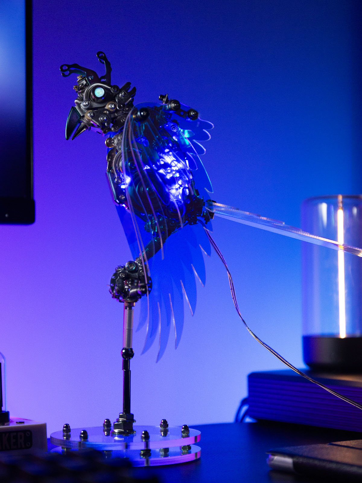 Decorative lamp with blue LED lights on a stand against a blue background