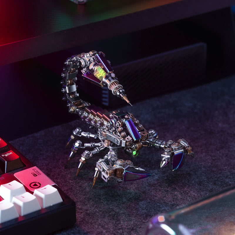 Metallic scorpion sculpture on a desk with computer equipment in the background