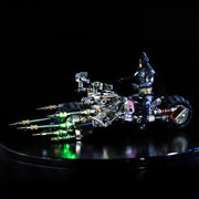 Toy figure of a superhero on a motorcycle with colorful lights against a dark background