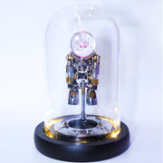Robotic figure inside a glass dome on a white background