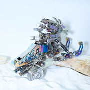 Metallic robot sculpture on a white surface with a light blue background
