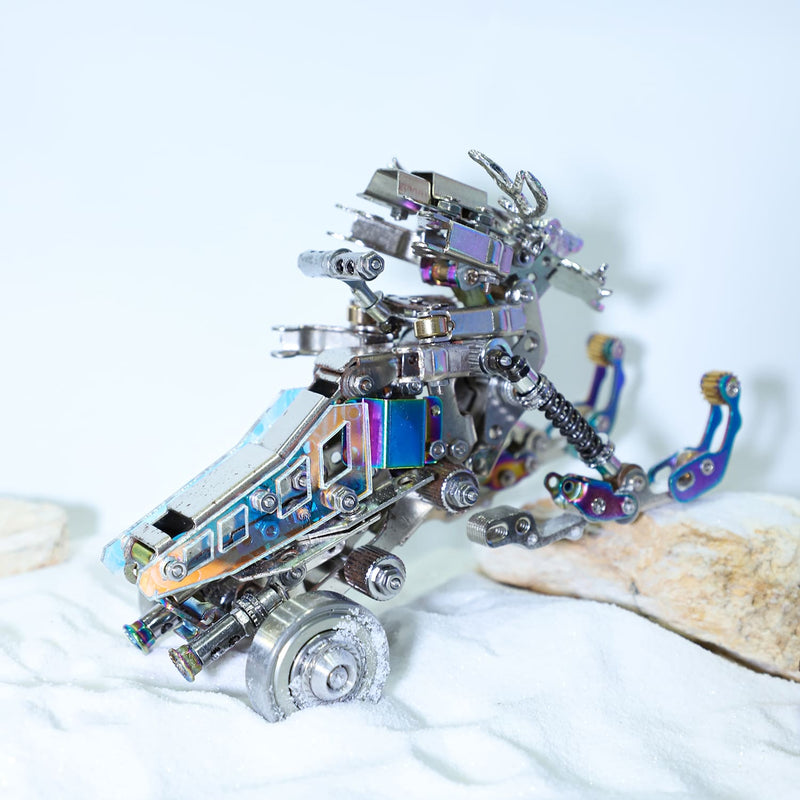 Metallic robot sculpture on a white surface with a light blue background
