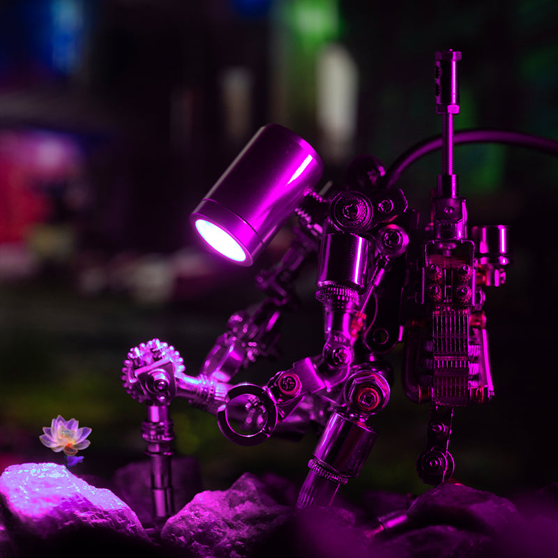 Metallic robot sculpture with glowing purple light on a dark background
