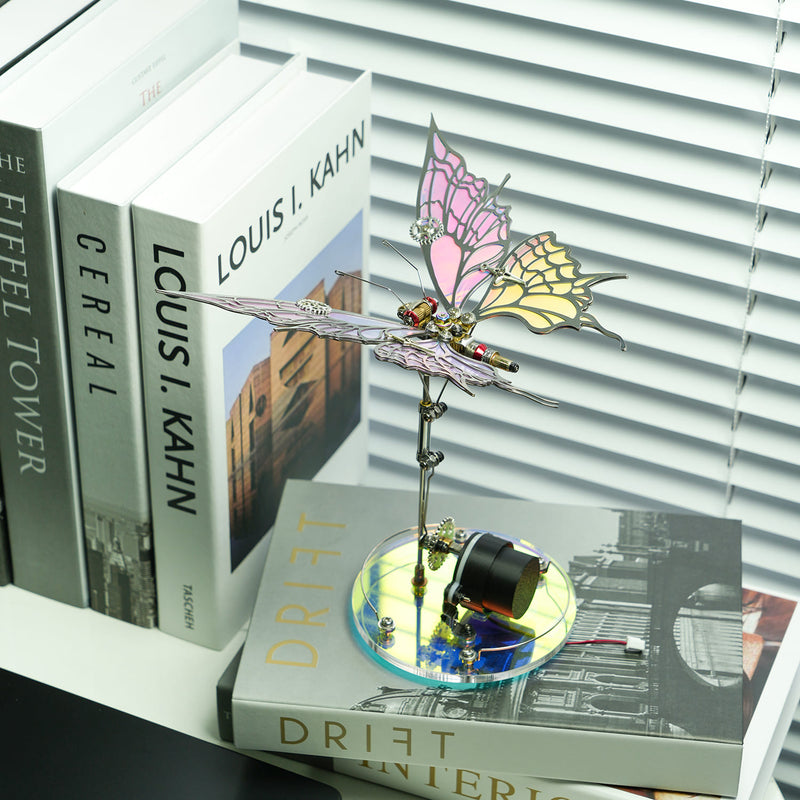 Decorative butterfly sculpture on a stack of books with a window blind background