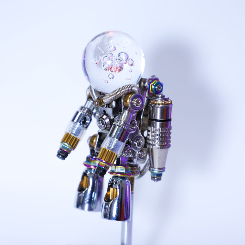 Metallic robot figure with a clear glass ball on a white background