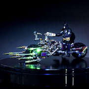Toy figure of a superhero on a motorcycle with glowing elements against a dark background