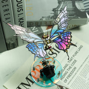 Colorful butterfly-shaped object with mechanical elements on a magazine background