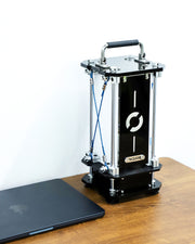 3D printer on a wooden table with a laptop