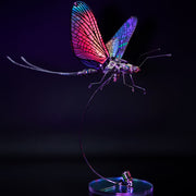 Colorful dragonfly-shaped lamp on a black background