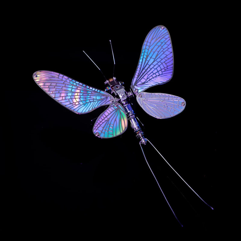 Artificial dragonfly with iridescent wings on a black background