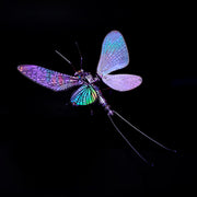 Colorful dragonfly-shaped object on a black background