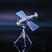 Model of a spacecraft with solar panels on a reflective surface