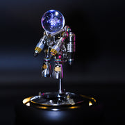 Metallic robot figure with a glowing crystal ball on a dark background