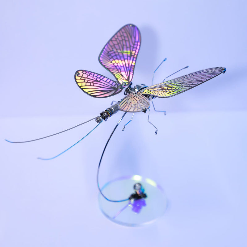 Colorful fly fishing lure with iridescent wings on a light blue background