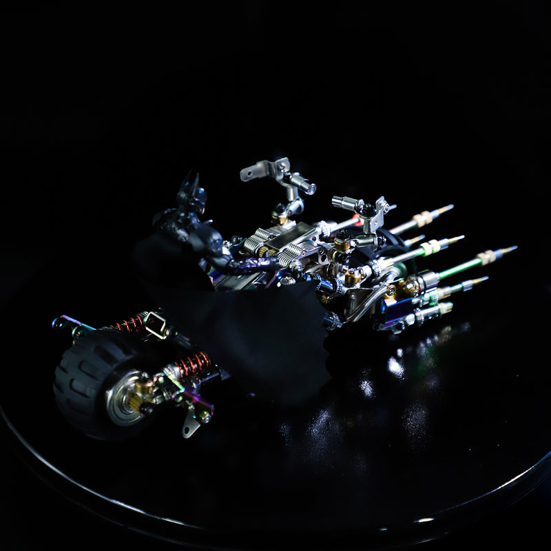 Mechanical claw with colorful components on a reflective black surface