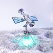 Model of a satellite on a snowy landscape