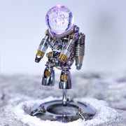Metallic robot figurine on a textured surface with a blurred background