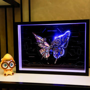 Futuristic butterfly design on a digital screen with a small figurine next to it.