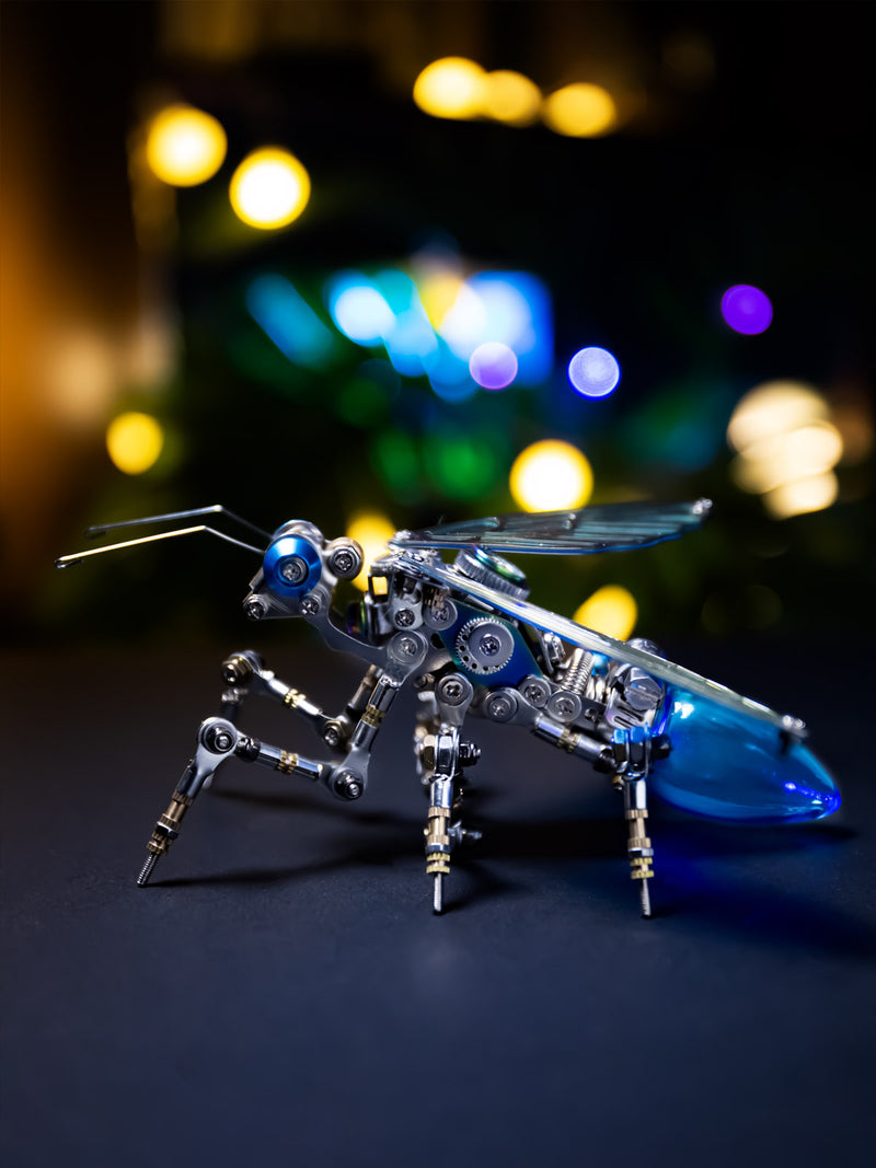 A model of a mechanical ant with color-shifting wings and glowing energy points, placed on a simulated natural terrain.