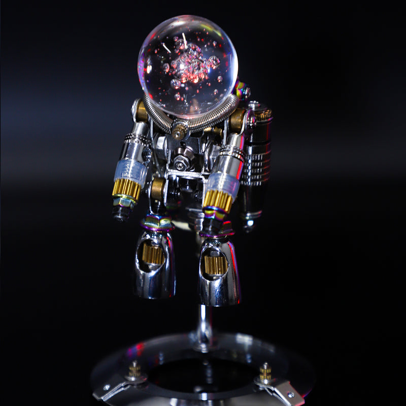 Metallic robot sculpture with a glass ball on a reflective surface