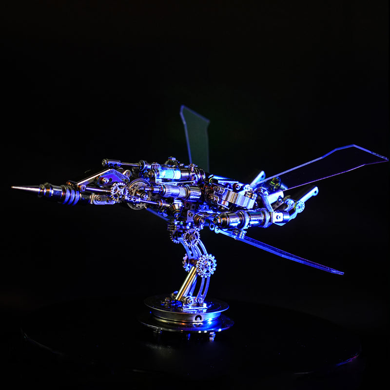 Metallic model of a spaceship with glowing blue lights on a black background