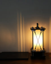 Modern lamp with geometric design casting shadows on a wall
