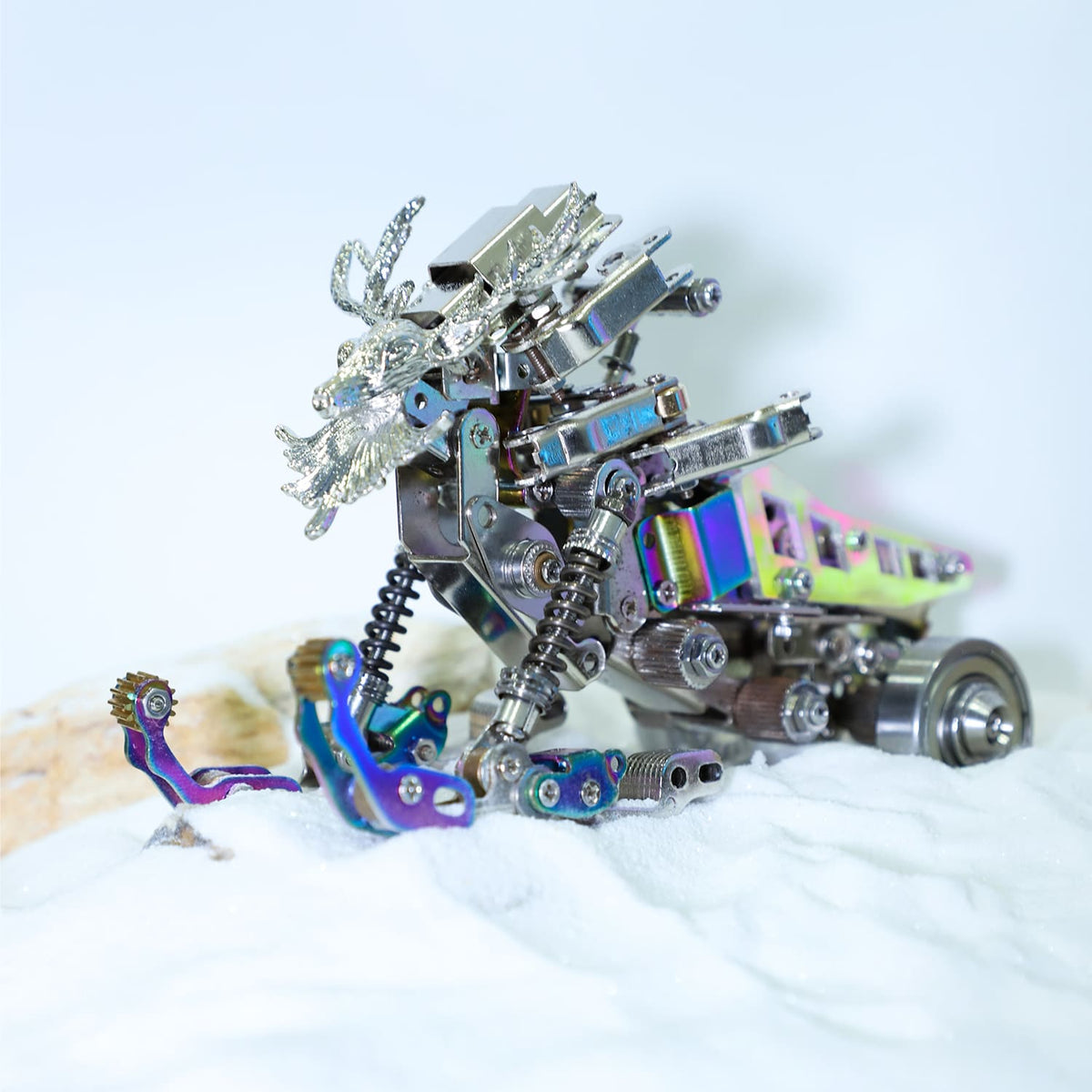 Metallic dragon sculpture with mechanical elements on a white background