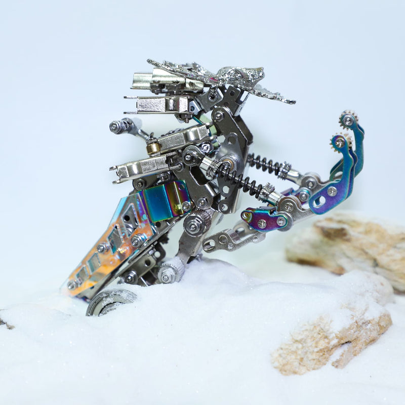 Metallic dragon sculpture on a textured surface with a light blue background