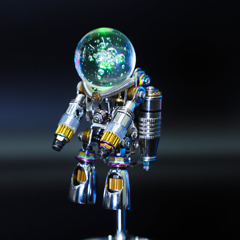 Metallic robot figure with a glowing green sphere on a black background