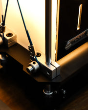 Close-up of a mechanical device with metal components on a wooden surface.