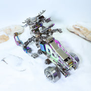 Metallic robot model on a white surface with a blurred background