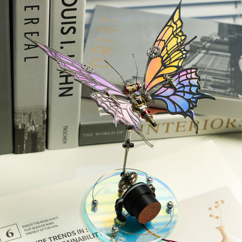 Colorful butterfly-shaped mechanical object on a white surface with books in the background