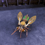 Mechanical insect model with gold and green details on a dark blue background